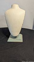 Front view of wooden necklace display bust on base