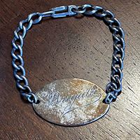Full view of sterling silver ID bracelet showing engraved plate and chain