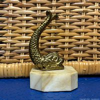 Full view of brass koi figurine on marble base