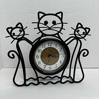 Front view showing cat frame and clock face