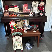 Full view of assorted Christmas decorations on piano and table
