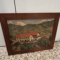 Full view of framed painting showing building and landscape