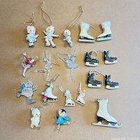 All 18 ice-skating themed ornaments laid out