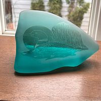 Front view of teal sea glass sculpture showing etched loon design