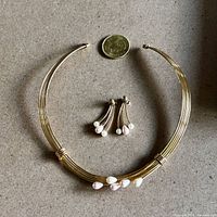 Choker necklace, pair of earrings, scale coin visible