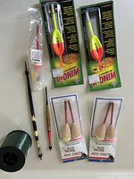 Packaged Wing-It and Eagle Claw floats, loose floats, green monofilament spool