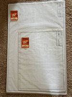 Two sealed packs of Clearprint Fade-Out tracing paper showing grid and labels