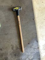 Full view of sledgehammer showing head, handle length, and condition