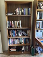Front view showing entire bookcase with five shelves and finish