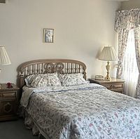 Full queen bed showing headboard, frame assembled with mattress and bedding