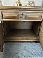 Nightstand cabinet doors open showing interior storage