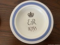 Front of Poole Pottery coronation plate showing crown, E II R, 1953 and coloured bands