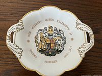 Front view of dish showing coat of arms, inscription and gilt trim