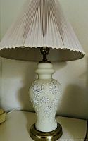 Full view of porcelain lamp with shade