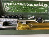 Open case showing sockets, ratchet, extensions, spinner and lid graphics