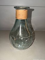 Front view of clear hand-blown glass vase with jute wrap showing overall form and condition