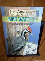 Front cover showing title, author, series, and woodpecker illustration