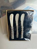 Front view of boxed set showing three spreaders