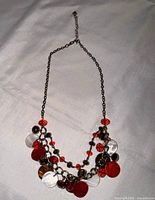 Full view of necklace laid flat showing chain, extender and bead arrangement