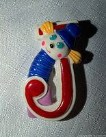 Front view of Sevi wooden letter J with clown design