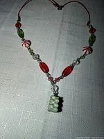 Entire necklace laid flat showing bead arrangement and pendant