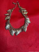 Full view of bracelet laid flat showing chain, extender, and leaf charms