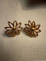 front view of both earrings on fabric background