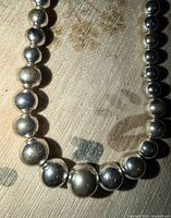 Close-up of graduated silver-tone beads