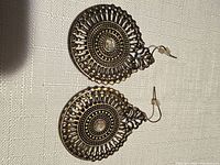 Front view of both earrings showing filigree design and crystal centers