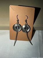 Front view showing design details of both earrings on card