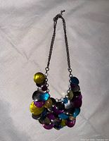Full view of necklace showing chain and multicolored disks