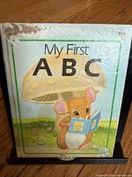 Front cover of My First ABC showing mouse illustration and wear