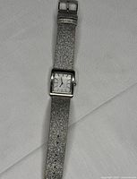 Full view of watch showing glitter strap and square face
