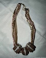 Full view of multi-strand necklace laid flat