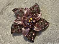 Front view of brooch showing overall design, colour and crystal placement