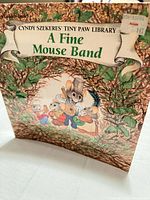 Front cover showing title, author series, publisher logo and illustrated mice band
