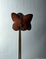 Front view of brown enamel butterfly stick pin