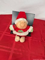 Front view of Ziggy plush in Santa outfit showing Jolly Holidays patch