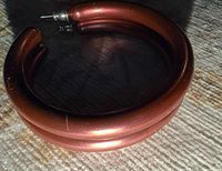 Single hoop earring close-up showing thickness, color and post fitting