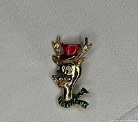 Front view of gold-tone Rudolph brooch with red hat and green scarf