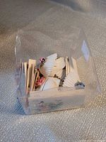 Shell place card holders and cards stored in clear plastic container
