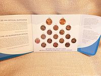 Open folder showing all 17 coins in place