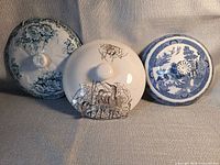 Group shot of all three decorated pot lids