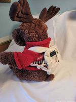 Side view highlighting antlers, sweater knit detail, and backpack straps