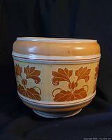 Front view of cylindrical cream and brown ceramic jardiniere