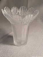 Front angled view showing ribbed body and scalloped rim