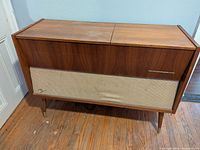 Closed Grundig wood console radio cabinet on tapered legs