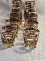 Ten matching Brutalist style glasses arranged in two rows viewed from front angle