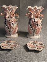 Front view of pair of vases with two small dishes