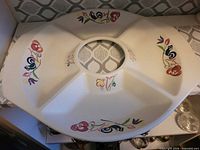 Top view of Poole divided dish showing cream base and floral motifs